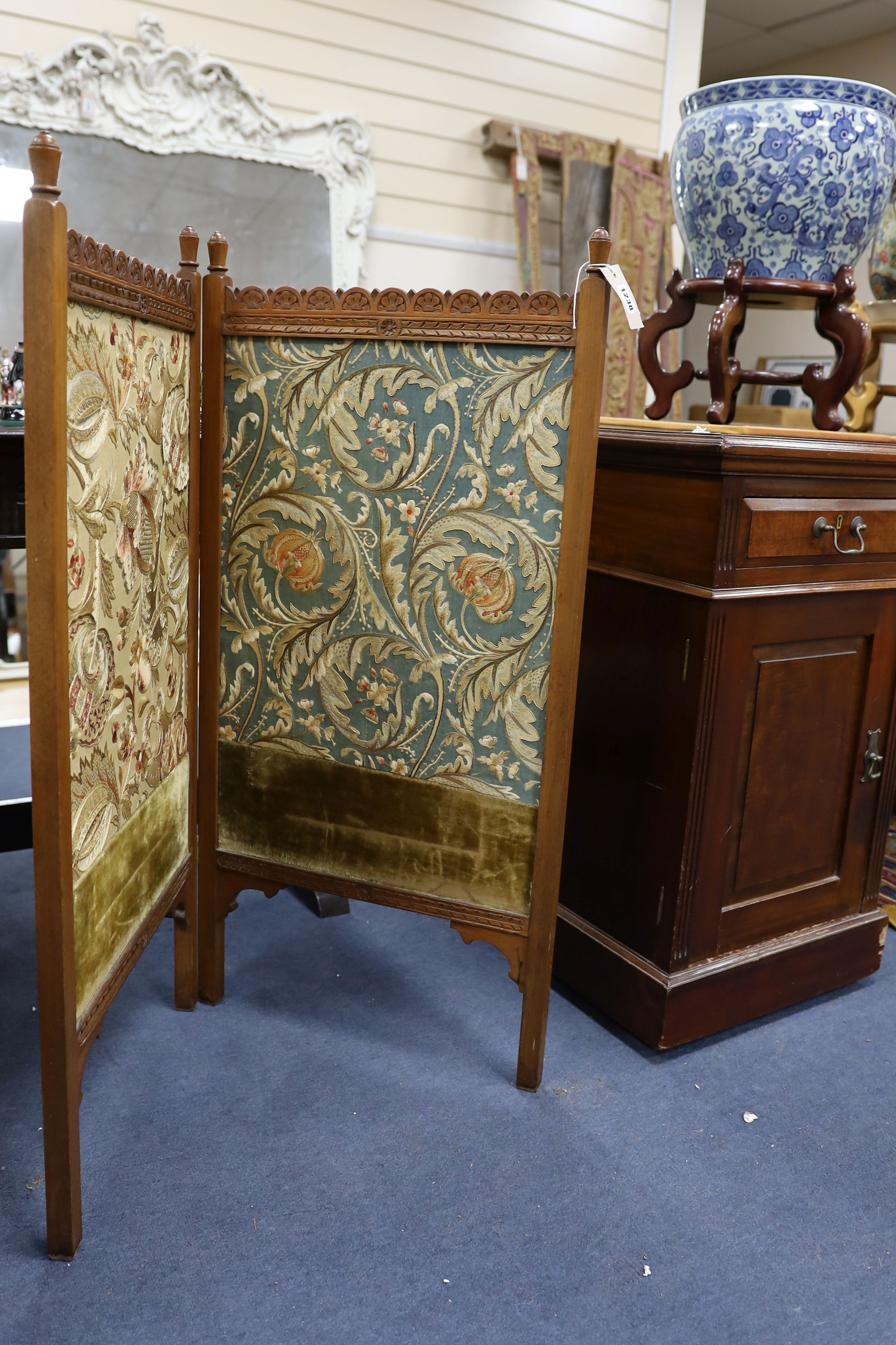 An Arts and Crafts Morris-style embroidered two-fold mahogany framed screen, each panel width 47cm, height 97cm, the embroidery design in the manner of May Morris